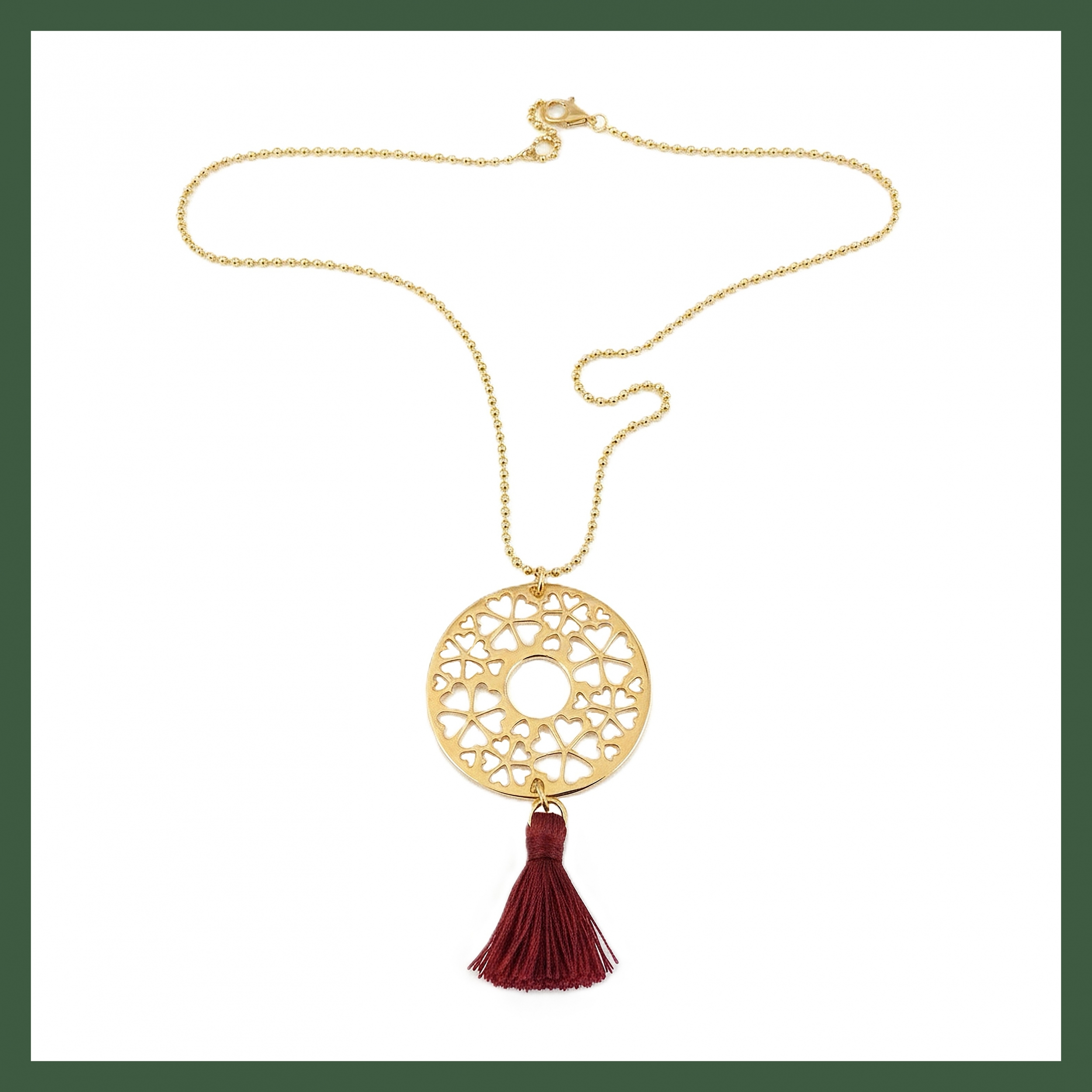 sautoir disque arabesque plaqué or pompon rouge foncé